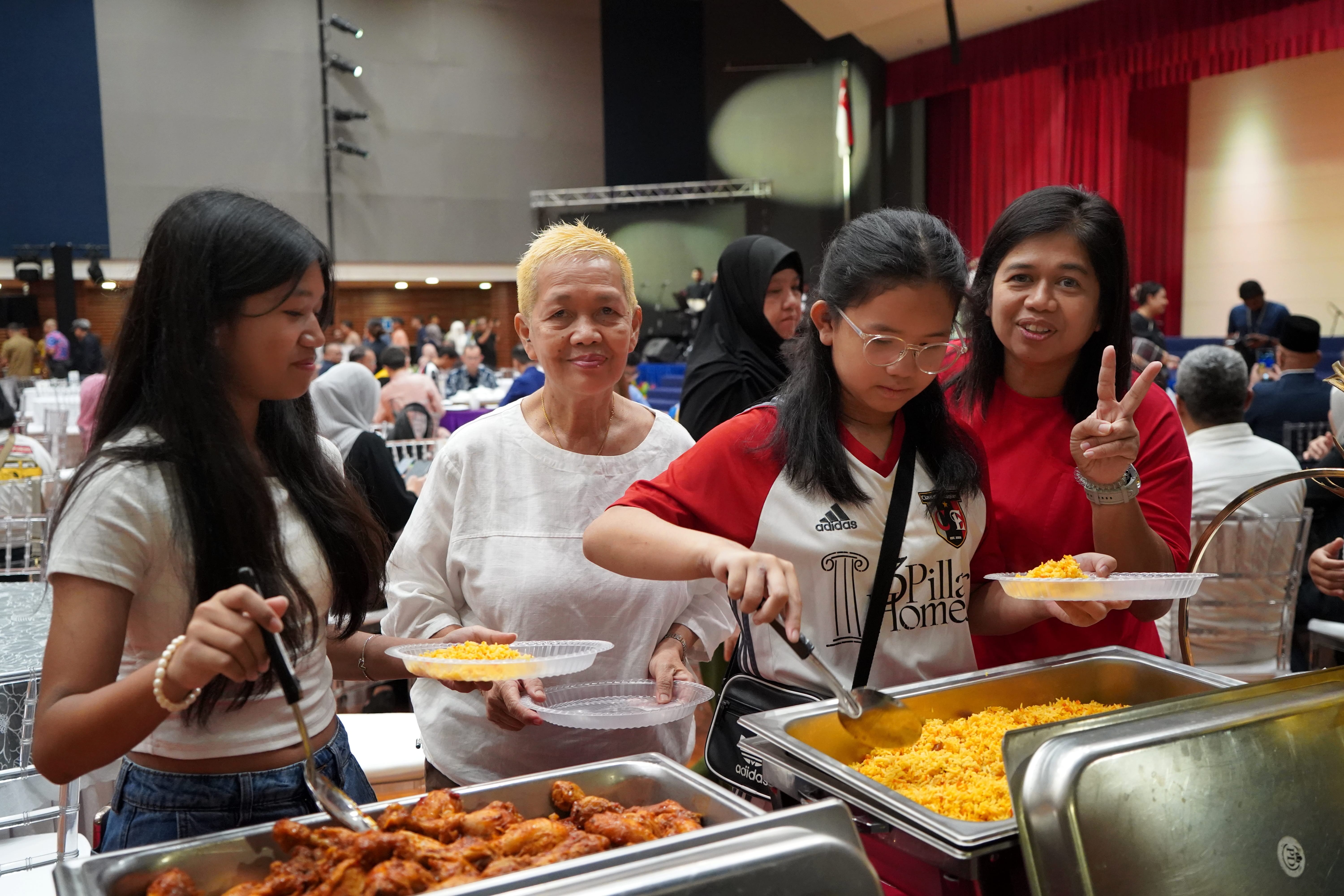 Attendees queue at a buffet station during the celebration.